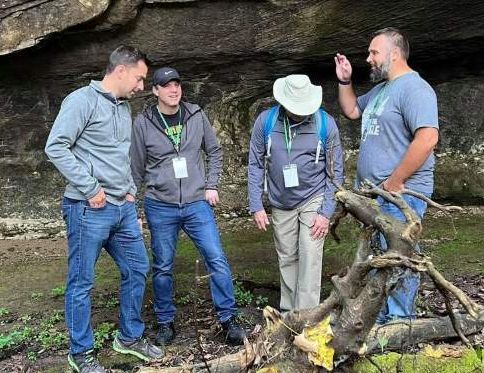 Hikers under a rock overhang on the nature hike